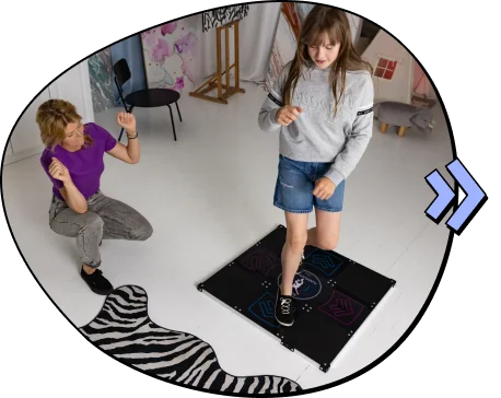 Group-155 - Interactive Mats L-TEK Two kids play on a large electronic dance mat in a bright room; one girl steps on the glowing pad as the other cheers.