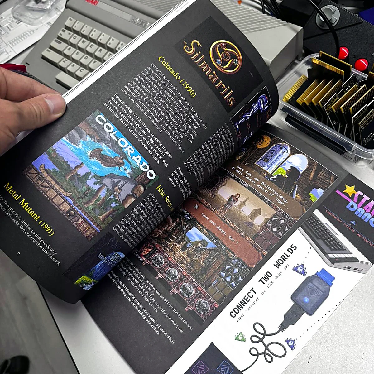 sq-nr01-game-reviews-spread - Interactive Mats L-TEK Atari Legacy Issue 01 open at a full-colour game review spread with Atari game screenshots